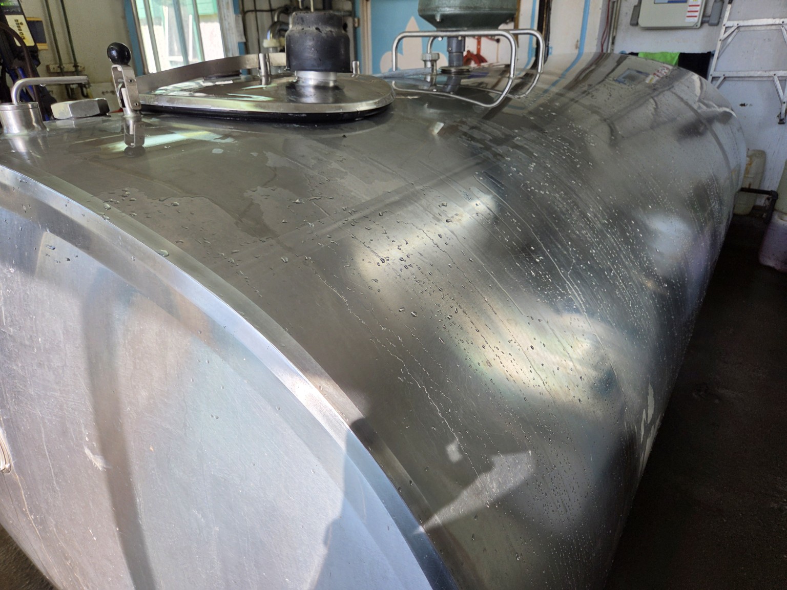 Empty bulk milk tank after the milk tanker has left